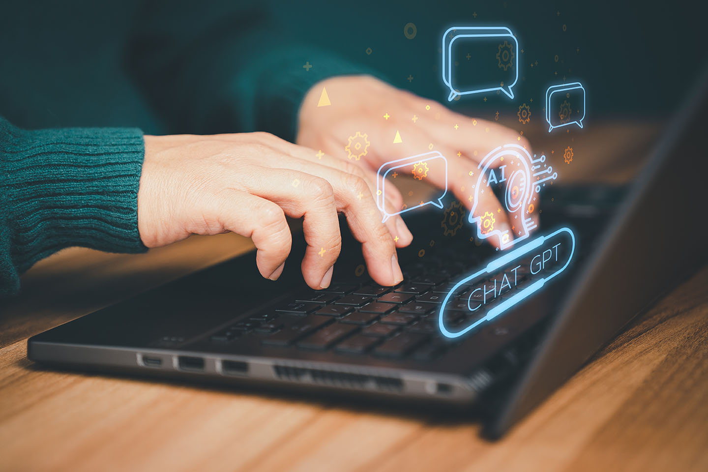 Hands using laptop with Chat GPT popping out of screen